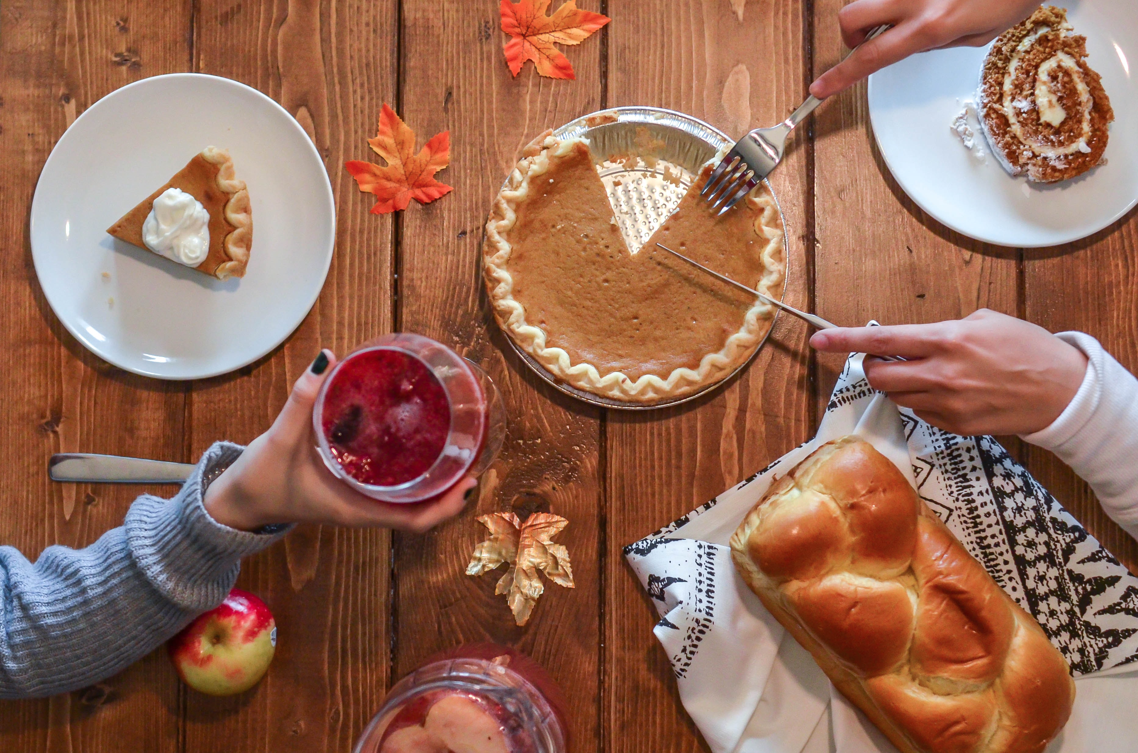 Thanksgiving Meal on Table Cutting Pie